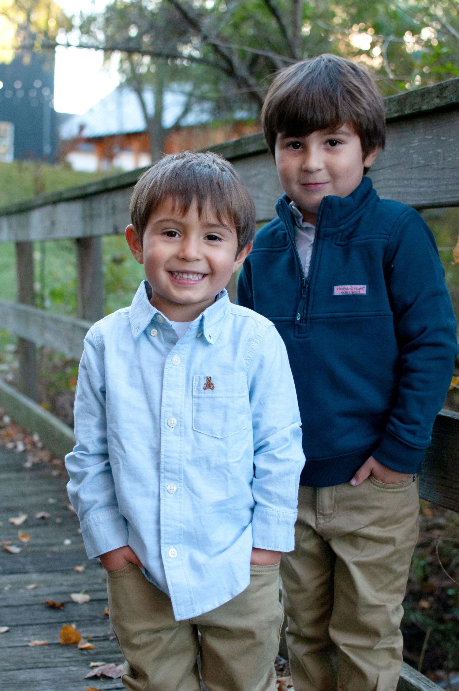 Two brothers standing by a bridge