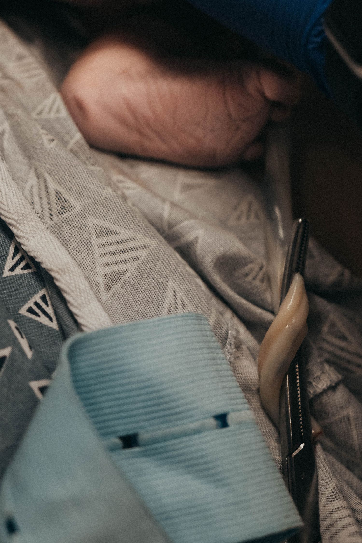Medical equipment and textured fabric in a dimly lit setting.
