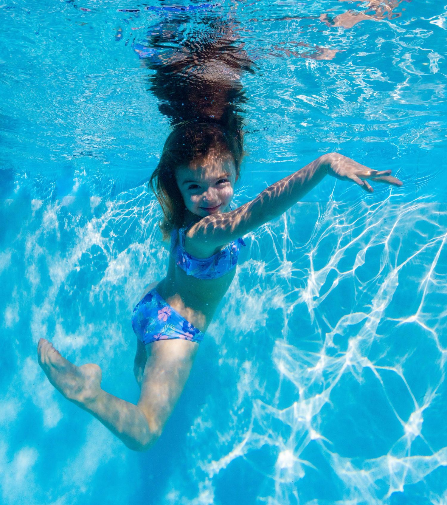 Little girl swimming underwater photo