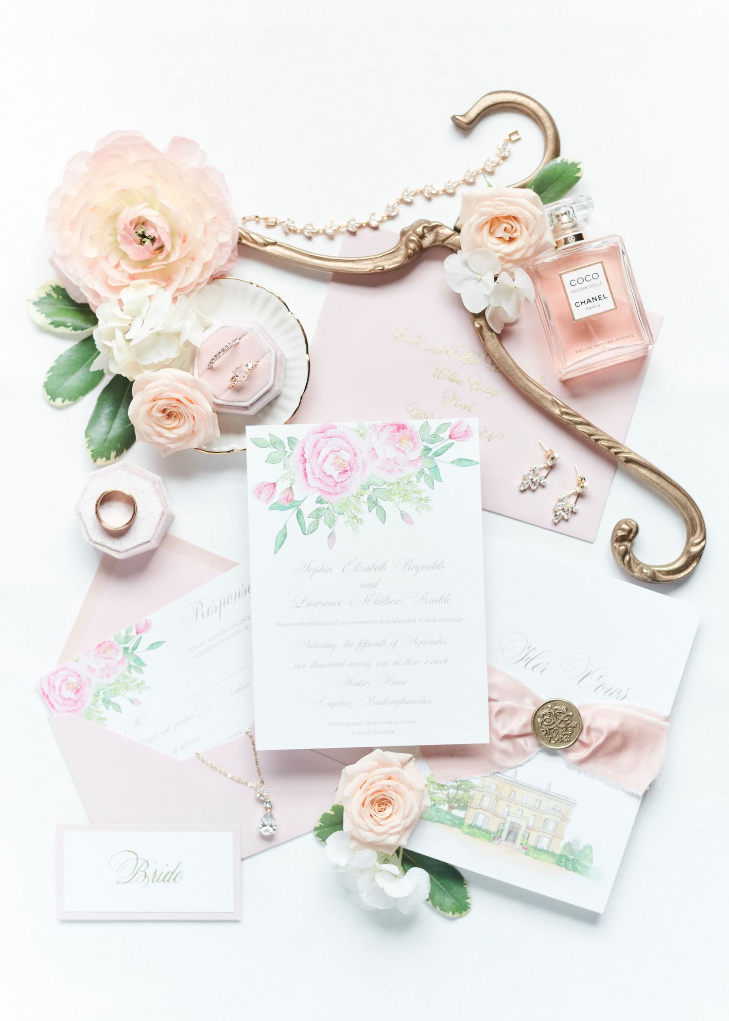 Hedsor House pink peach bridal flatlay with wedding stationary, flowers, jewelry. by Norwich's best wedding photographer