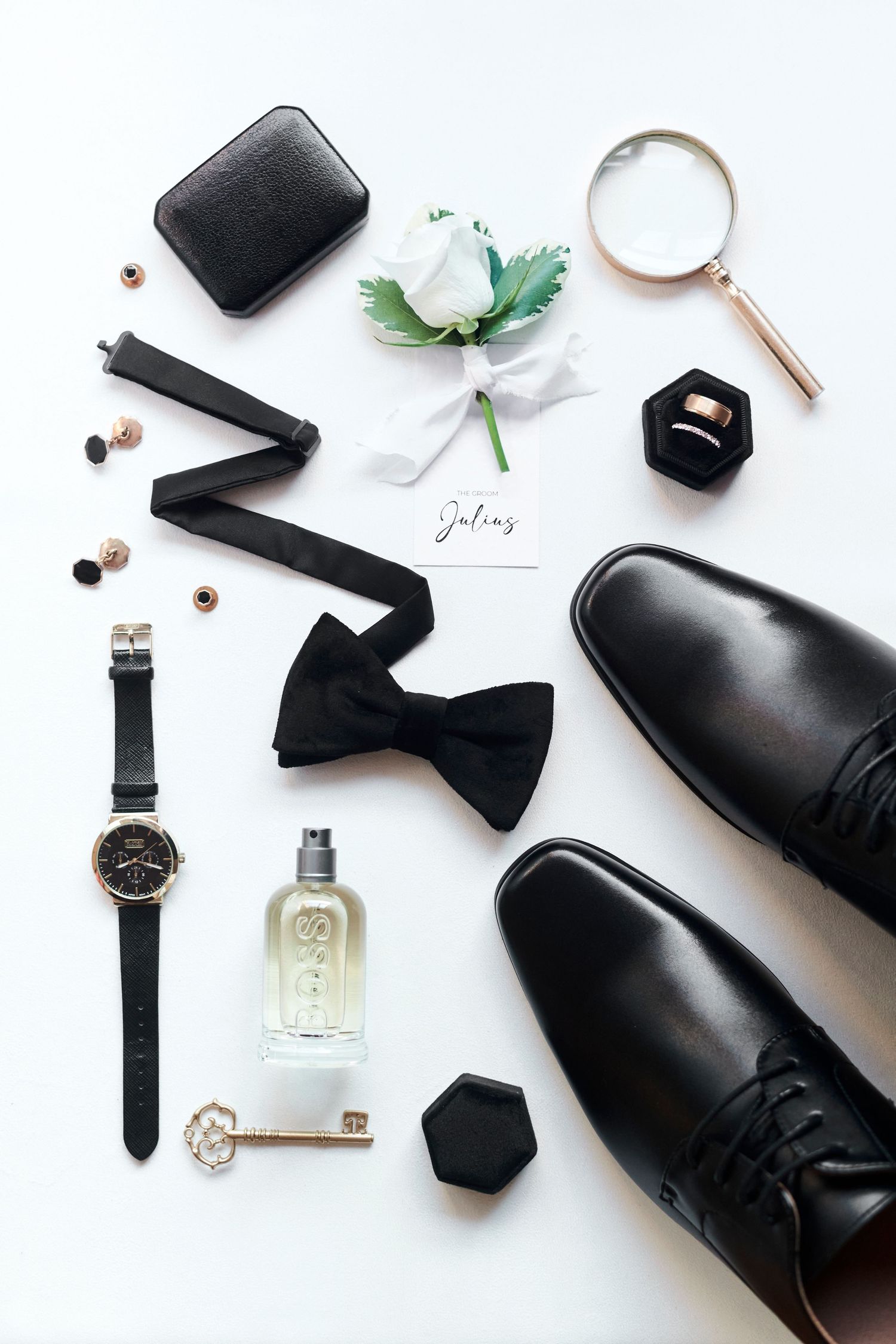 grooms bow tie and luxury outfits details displayed in a flatlay. by Norfolk wedding photographer Faye Amare