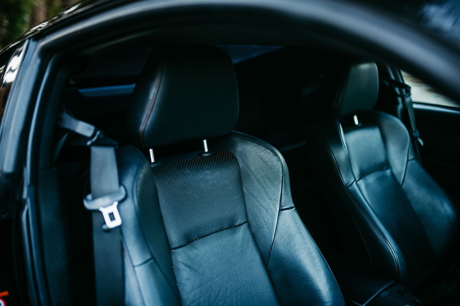 Black leather sports seats inside a performance vehicle.