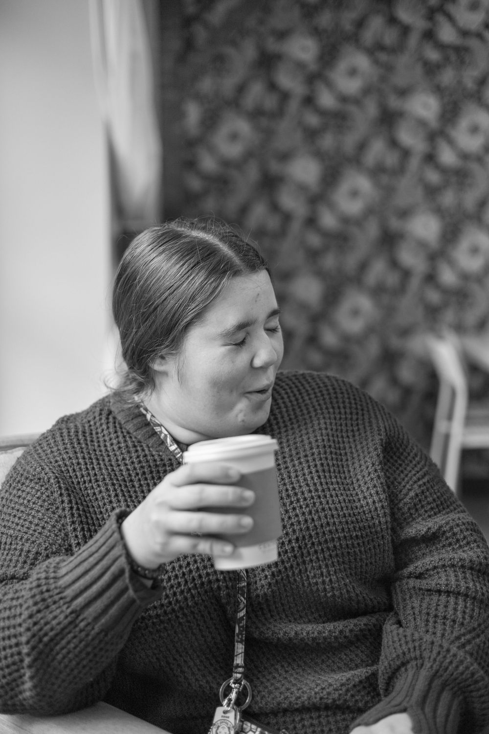 Person in knit sweater resting head on hand in sequence.