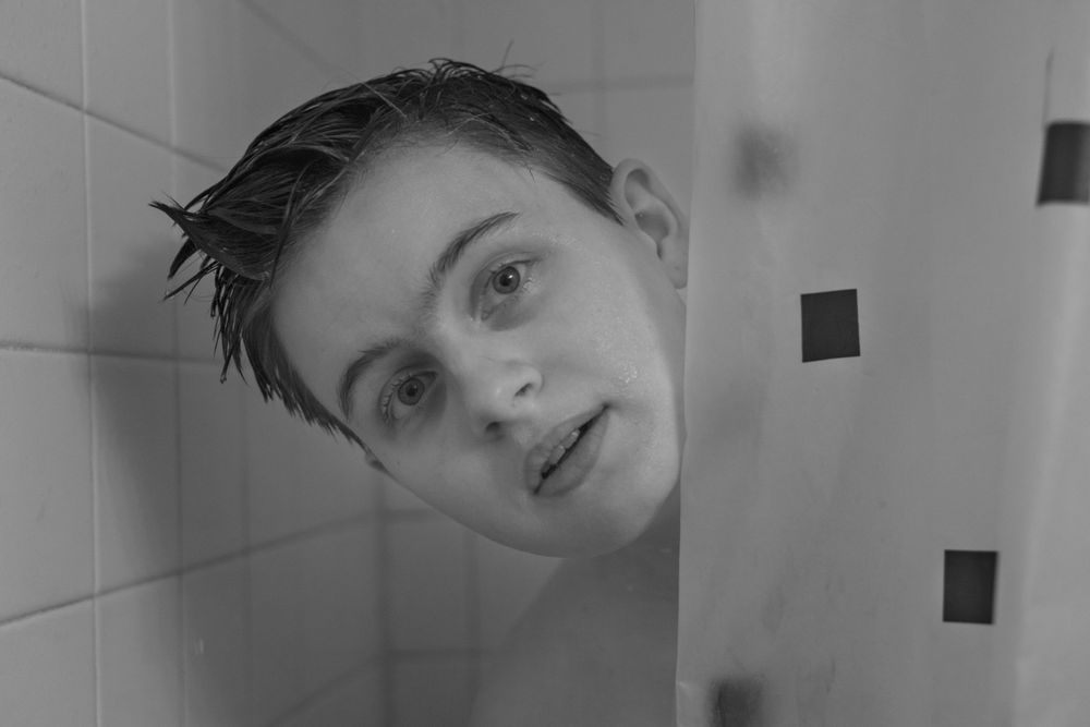 Series of bathroom mirror reflections in black and white.