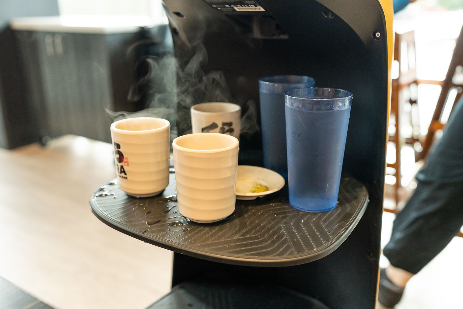Robot bringing hot water and iced water at Kura Revolving Sushi Bar in Bellevue.