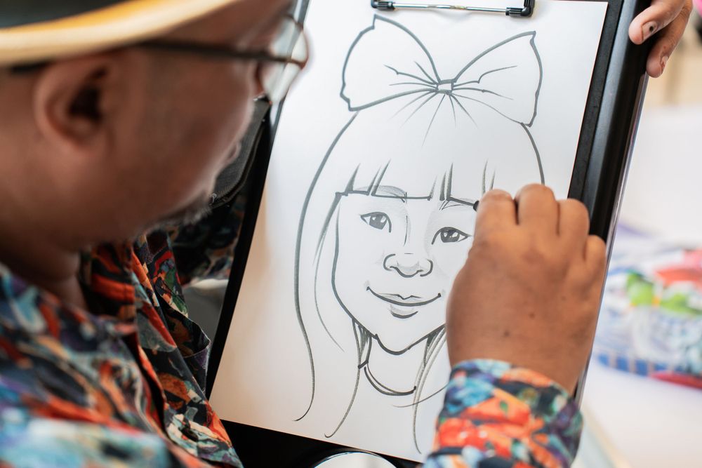 An artist sketches a portrait showing attention to detail on the bow and facial features.