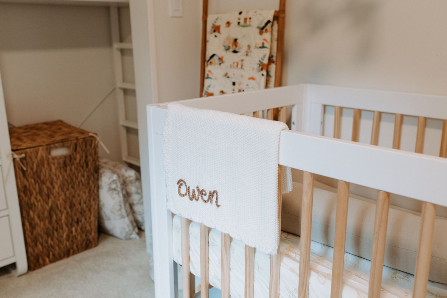 Light and airy nursery featuring natural wood furniture, white walls, and soft textiles.