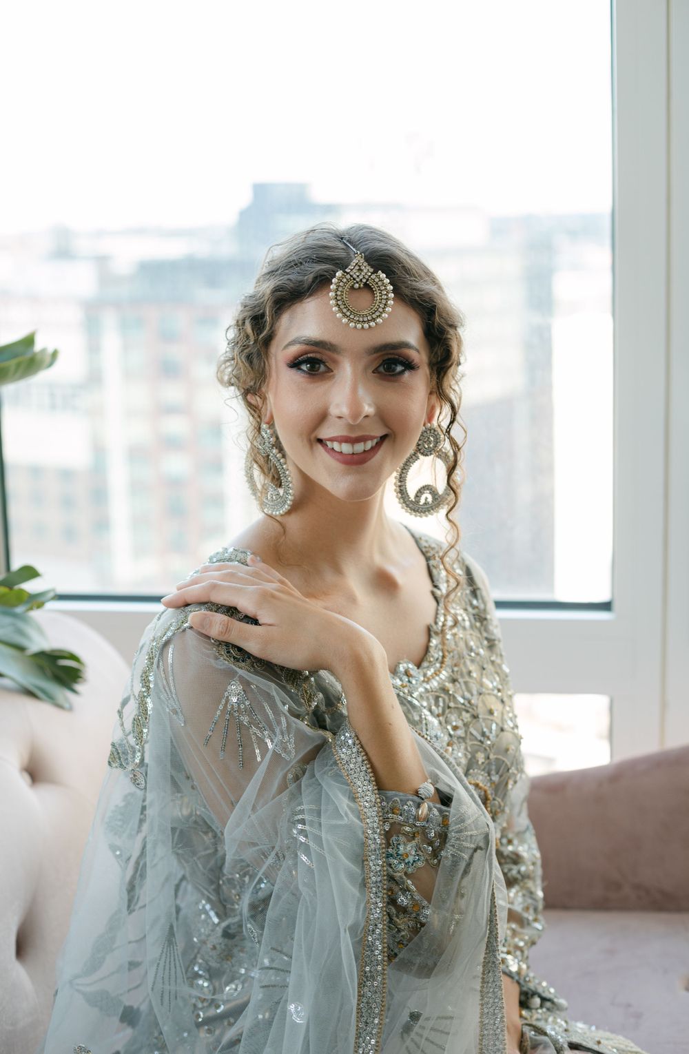Traditional South Asian bridal attire featuring ornate silver embellishments and jewelry.