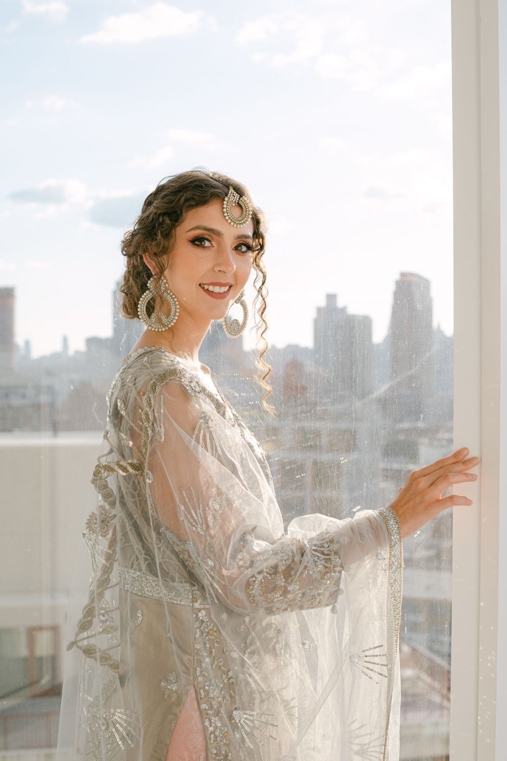 Ethereal silver embroidered dress captured against New York City's urban backdrop.