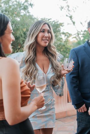 Friends enjoying drinks at an outdoor social gathering.
