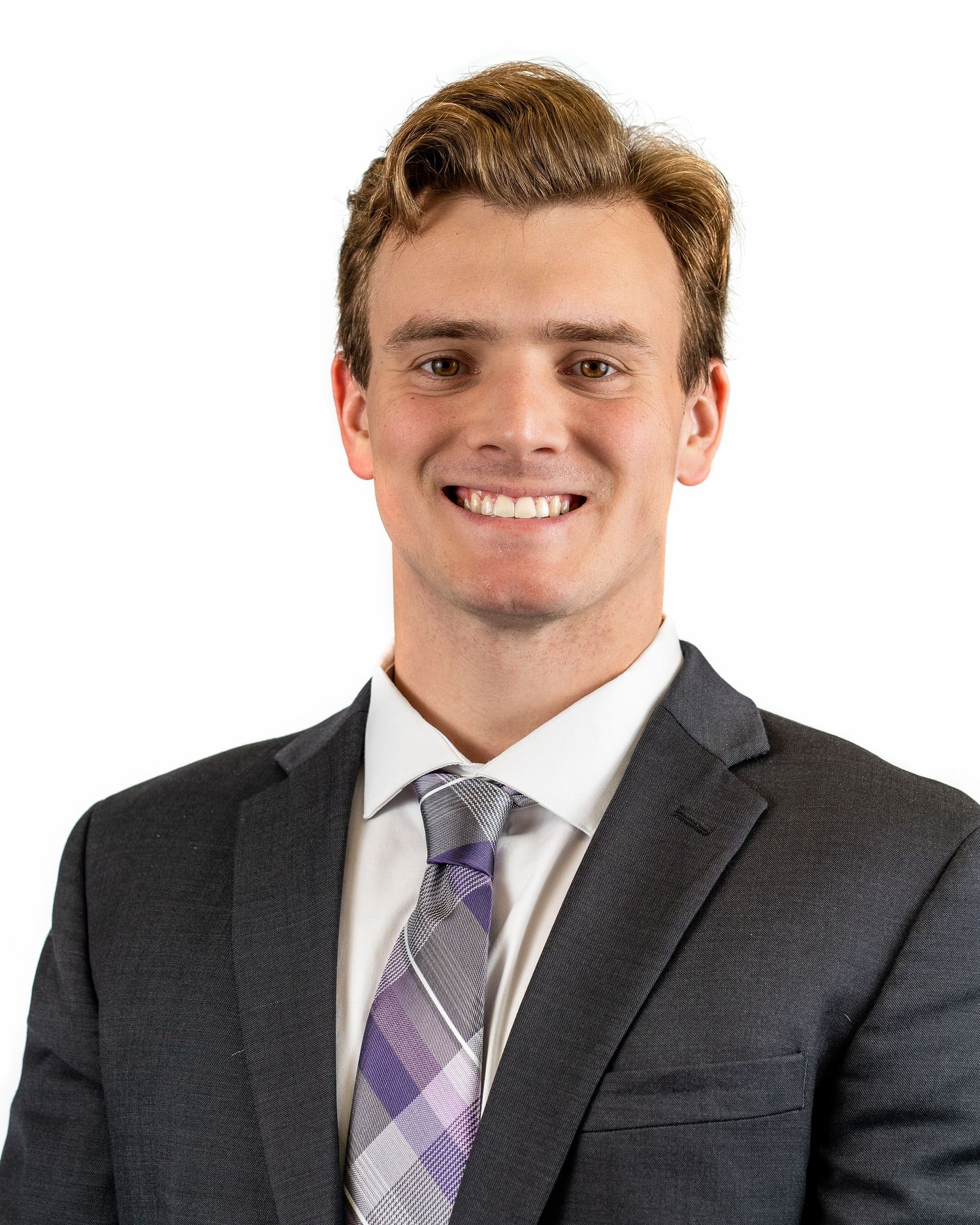 Professional business portrait of person in dark suit with purple plaid tie.