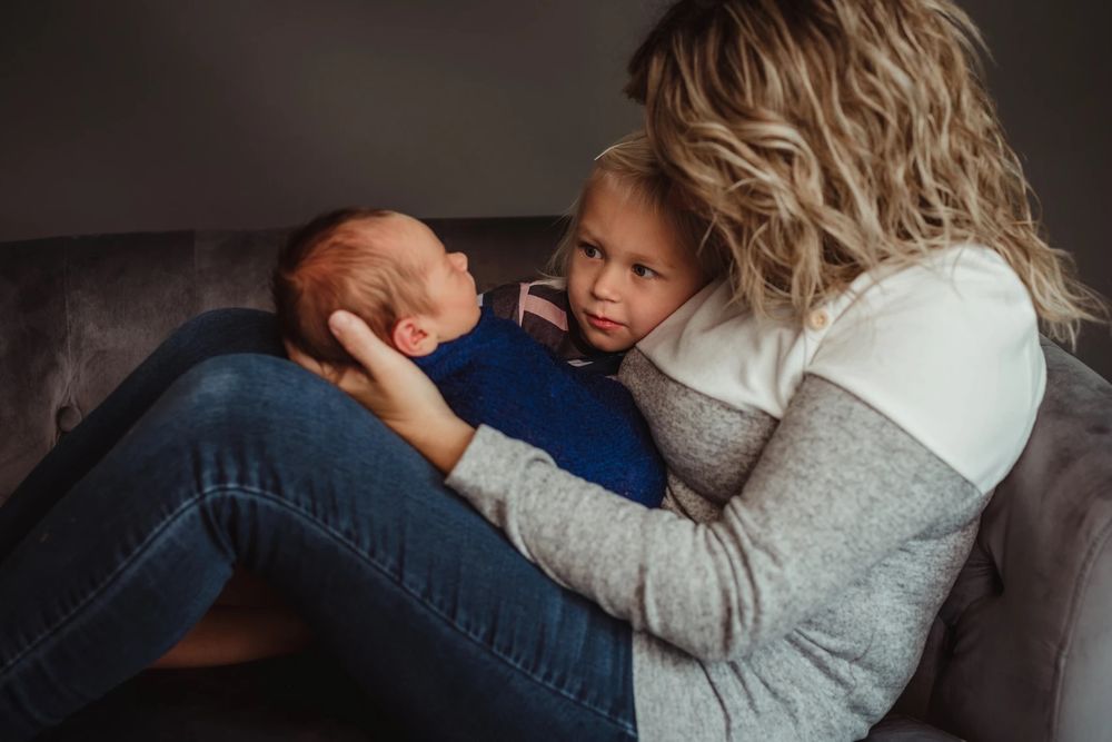 Intimate family portrait session showing gentle embraces in muted tones.