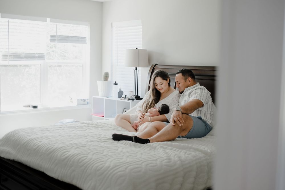 A bright, minimalist bedroom setting with white bedding and natural light.