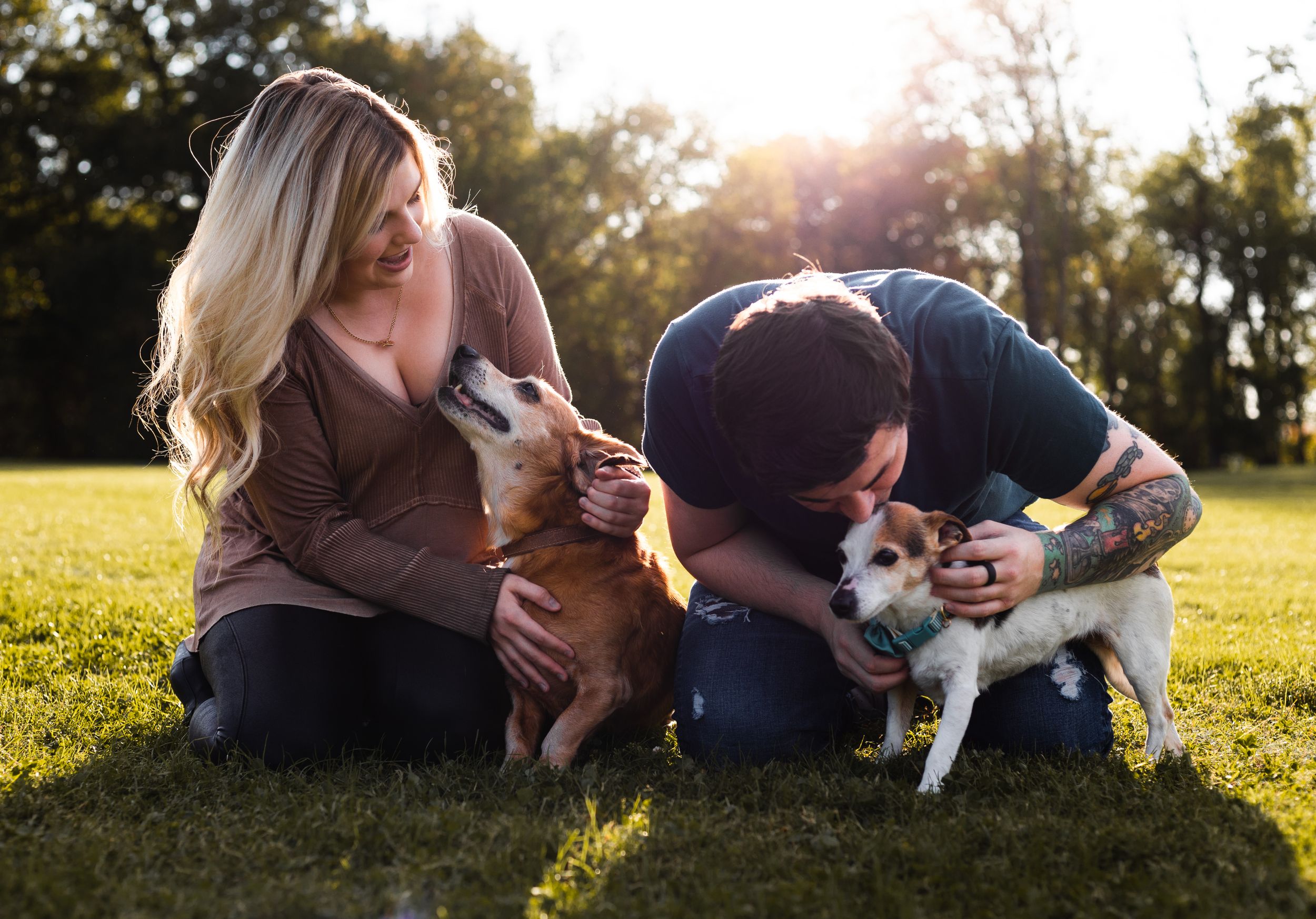 young adult couple loving on their puppies