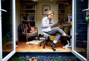 Environmental portrait of female artist in her studio.