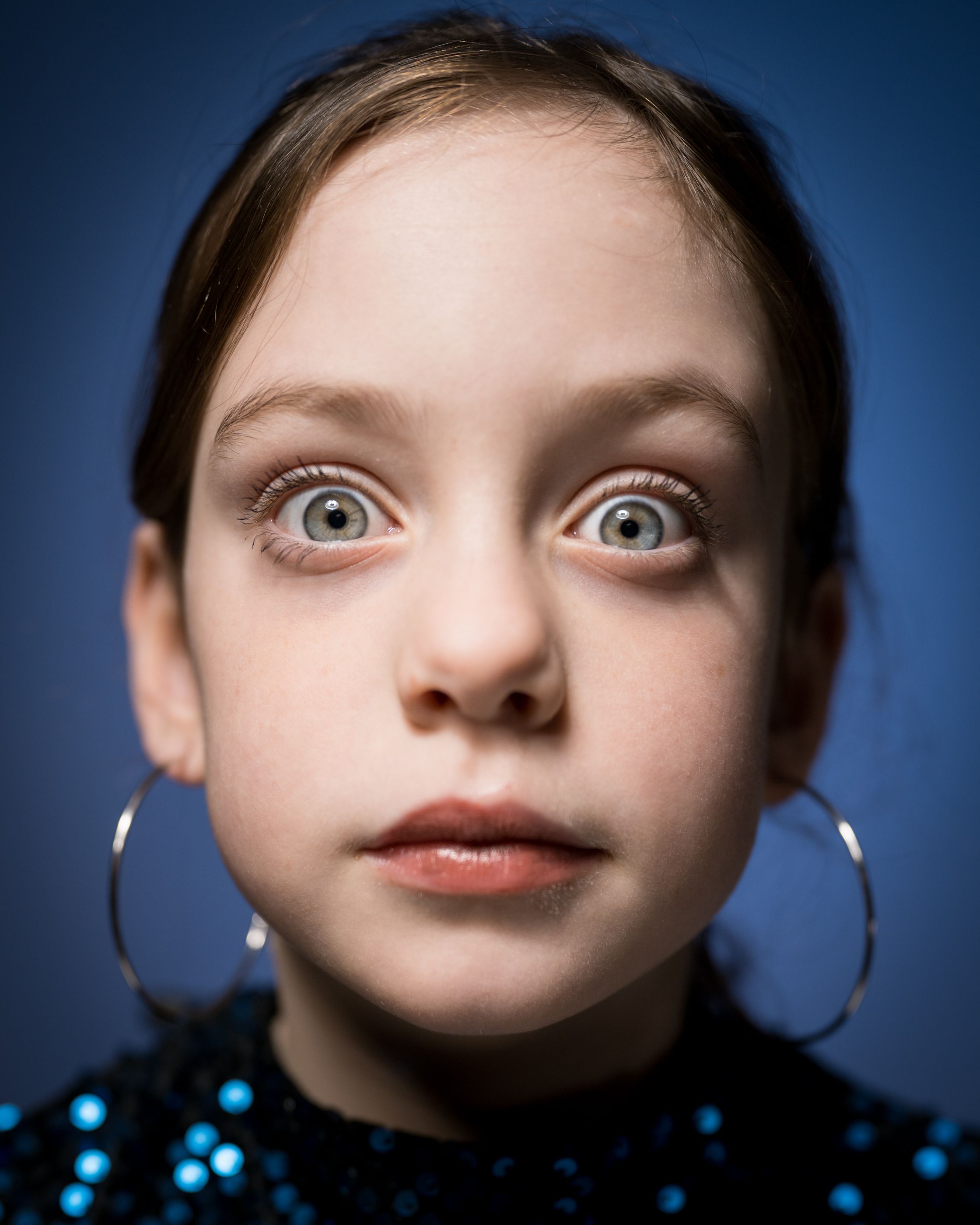 Portrait of young lady in blue sequin dress.