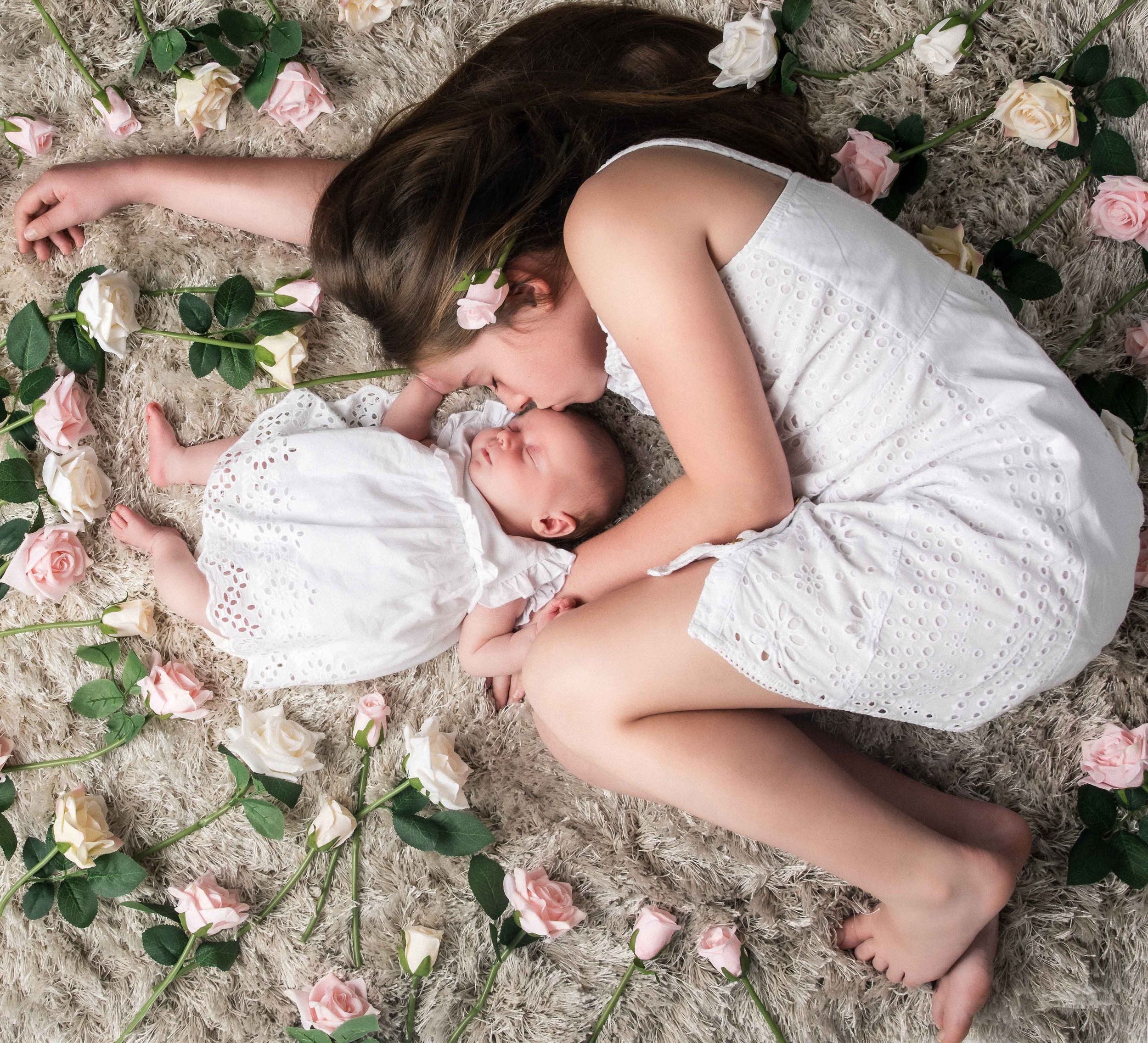 Portrait of 2 girls lay in roses