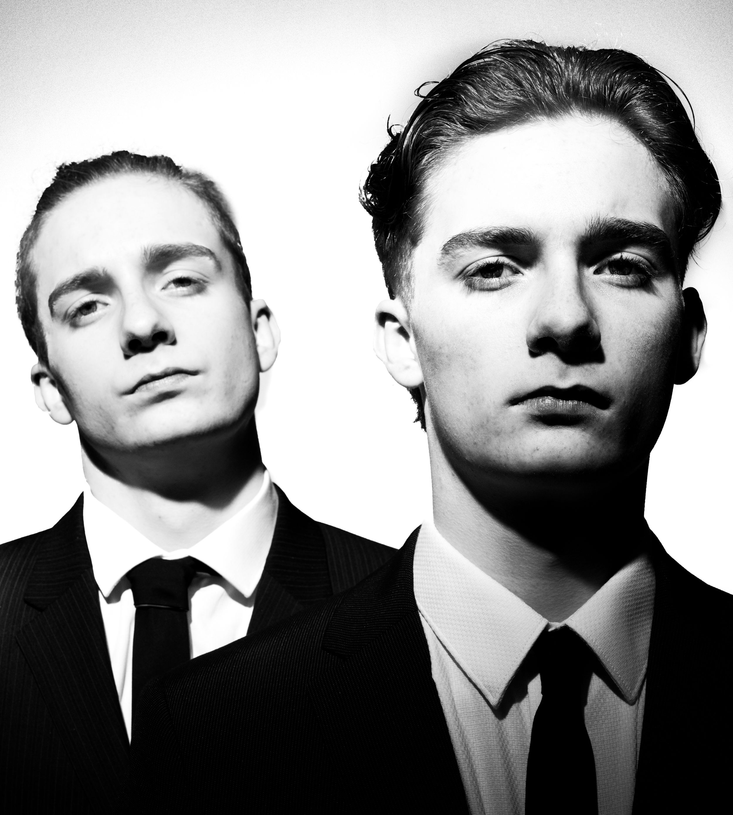 Dramatic black and white portrait series showing six people shot from below against white background.