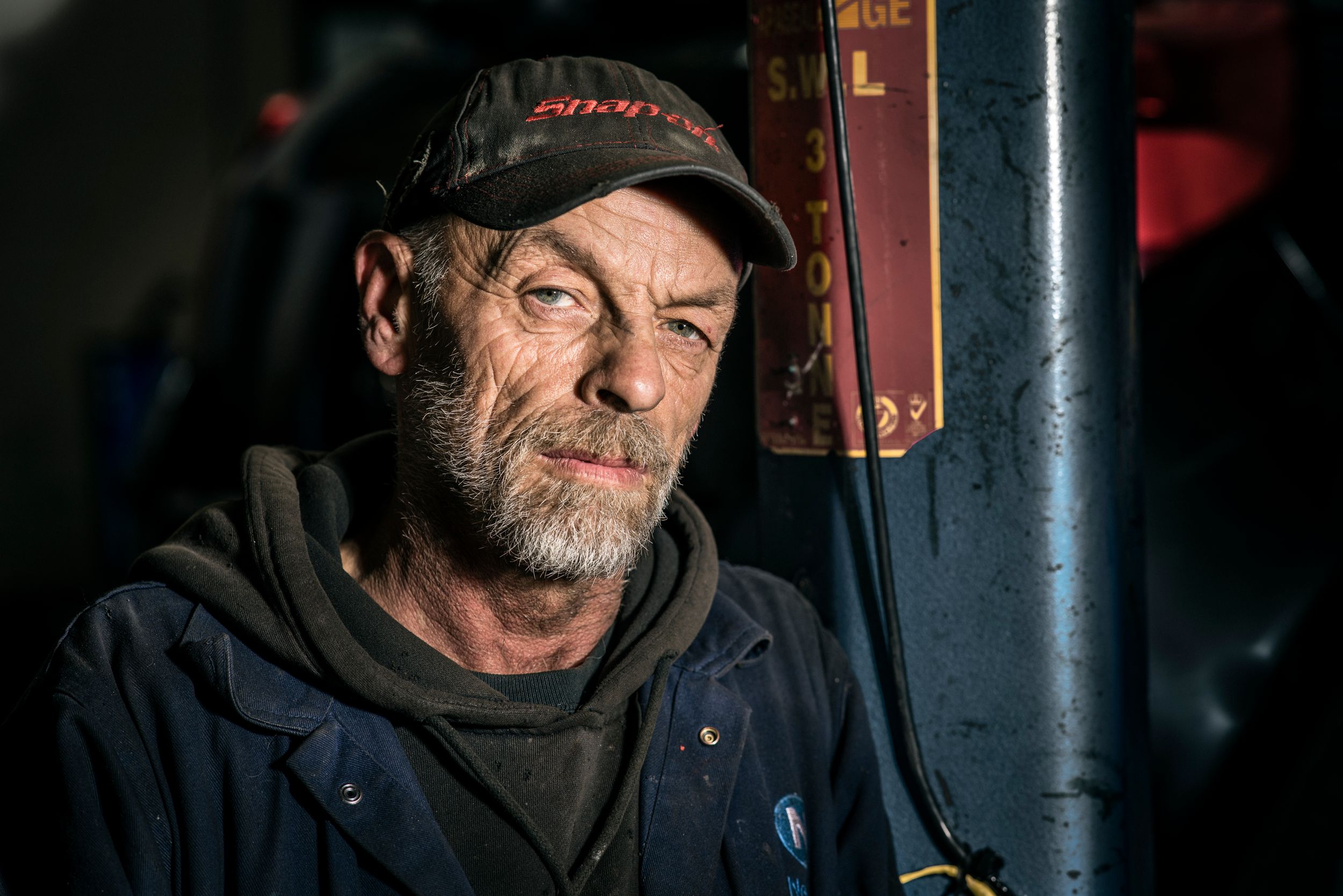 Environmental portrait of mechanic in situ.