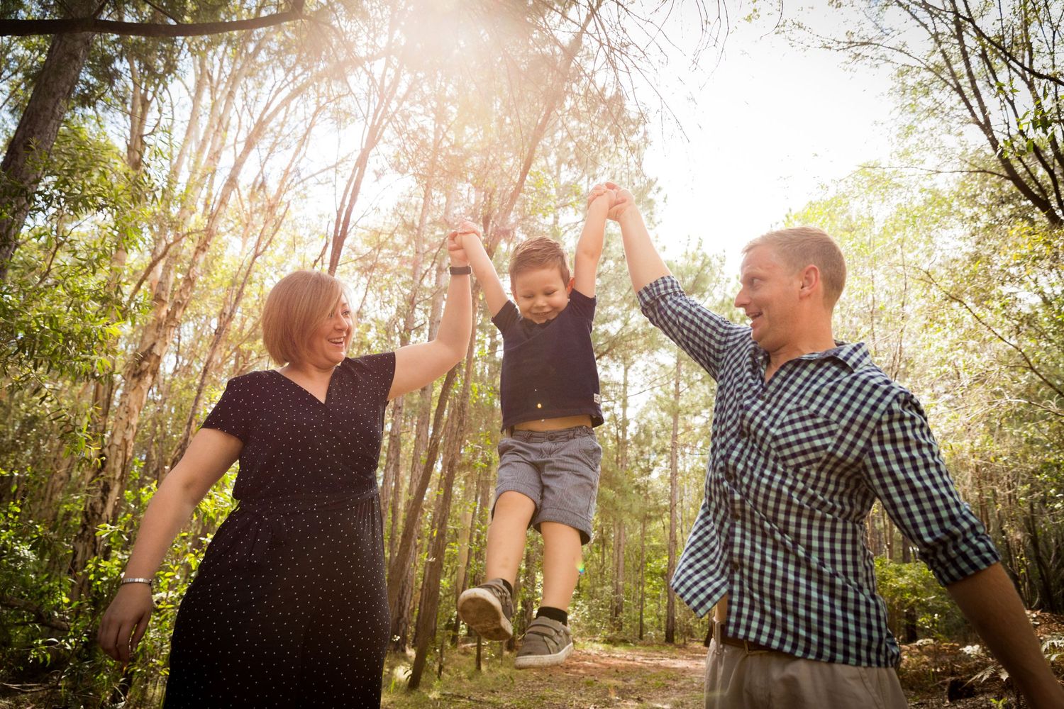 Family portrait session swinging son amongst the trees North Lakes woodlands