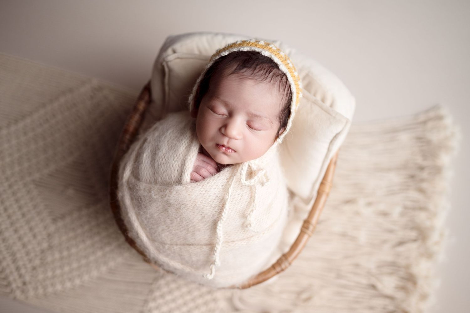 Professional newborn photography showing baby sleeping in various poses on white textured backdrop.