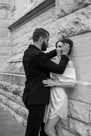 Romantic black and white portrait against stone wall texture.