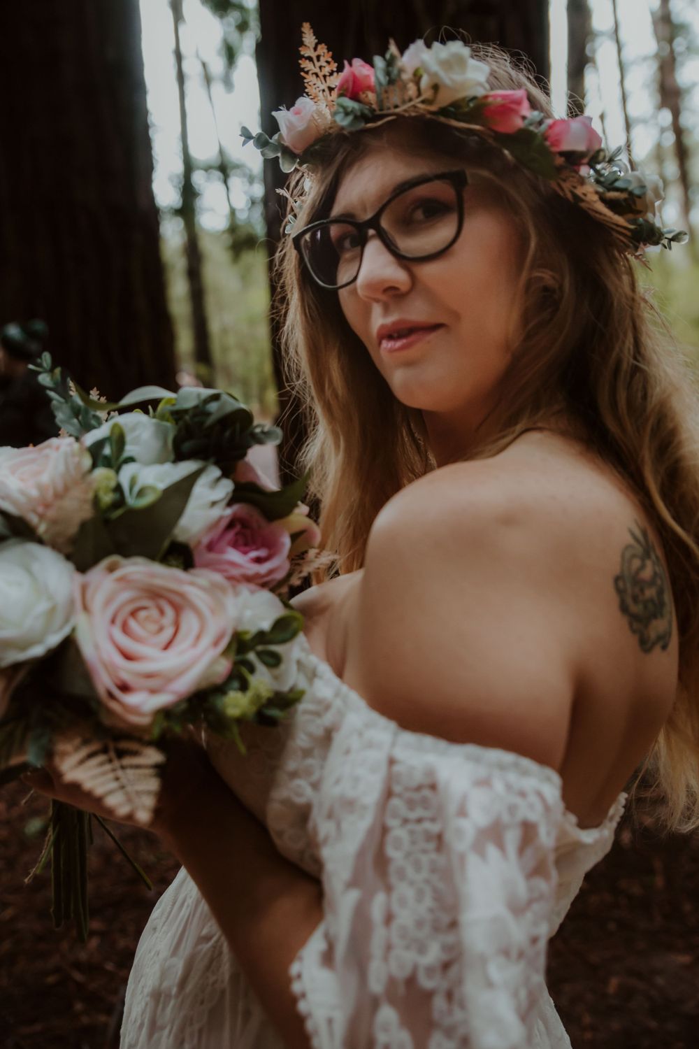 A romantic forest bridal portrait features lace dress and floral crown details.