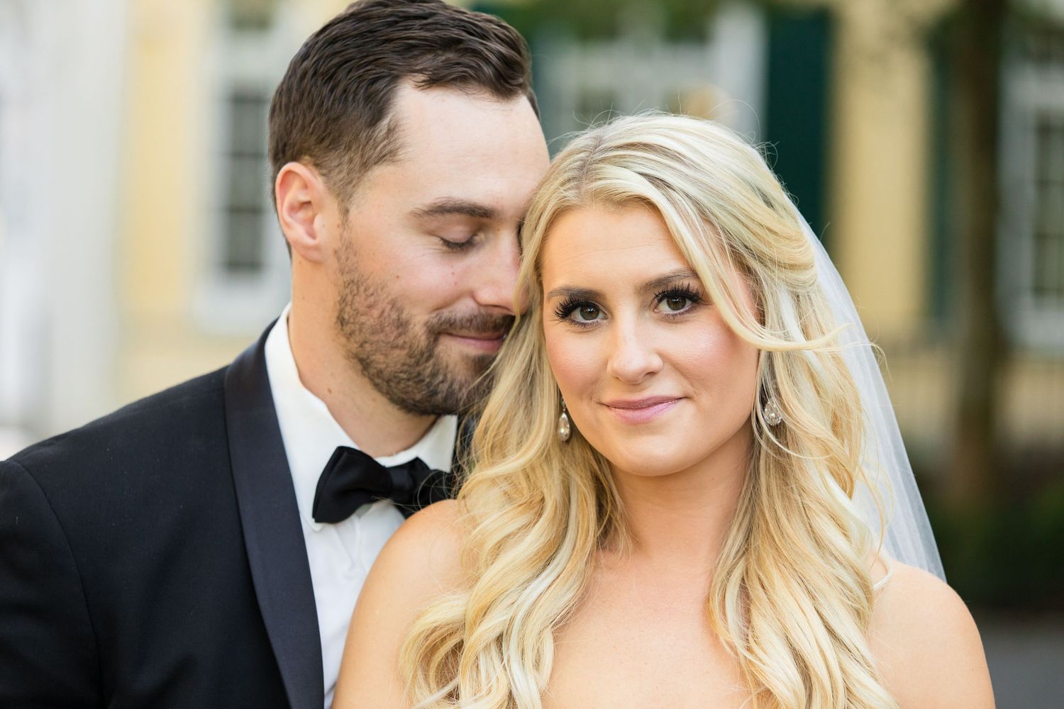 Close-up romantic wedding portrait in formal attire.