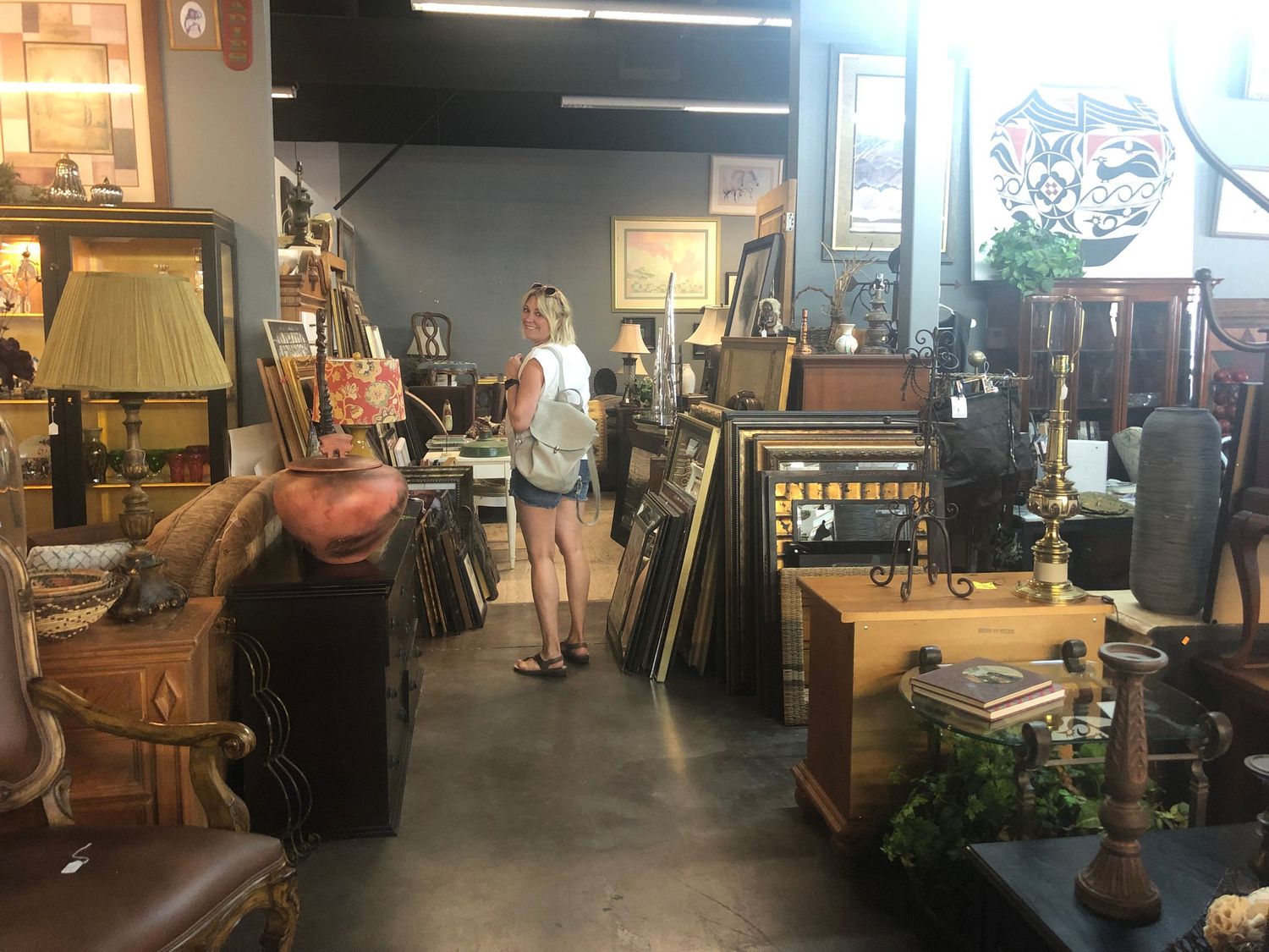 Dimly lit vintage store interior with antique furniture and decorative items.