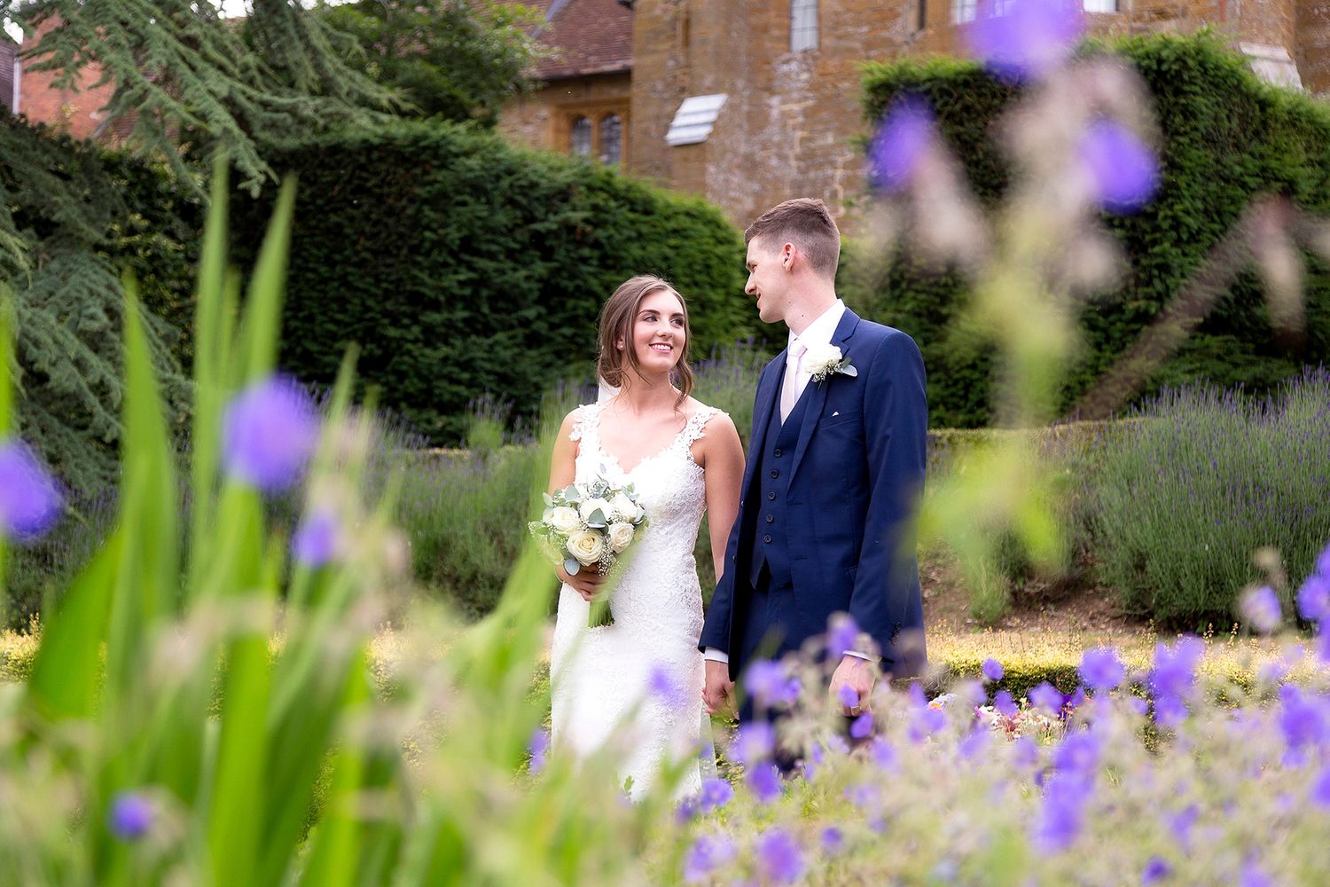 Lauren and josh walking through the gardens at falsely hall hotel and spar northampton