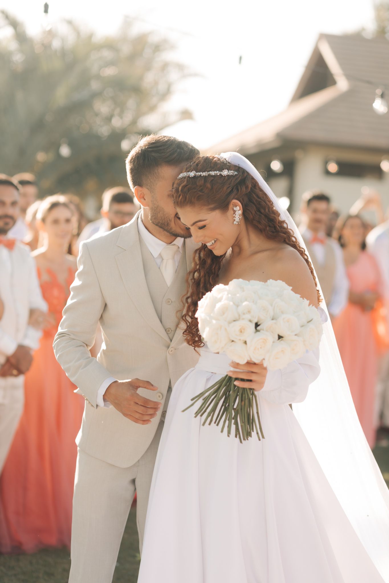 Wedding ceremony at the ornate altar of a historic Catholic church with decorative religious artwork.