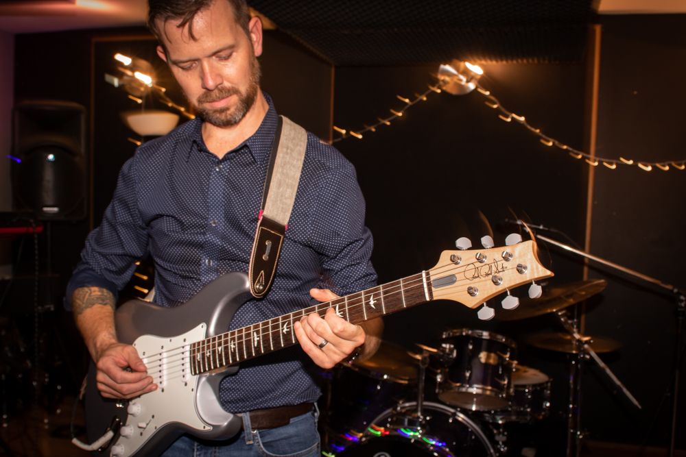 man playing electric guitar