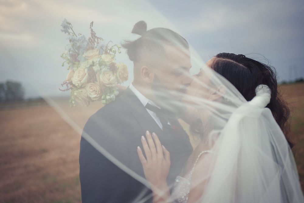 Romantic veiled portrait with double exposure effect against natural landscape.