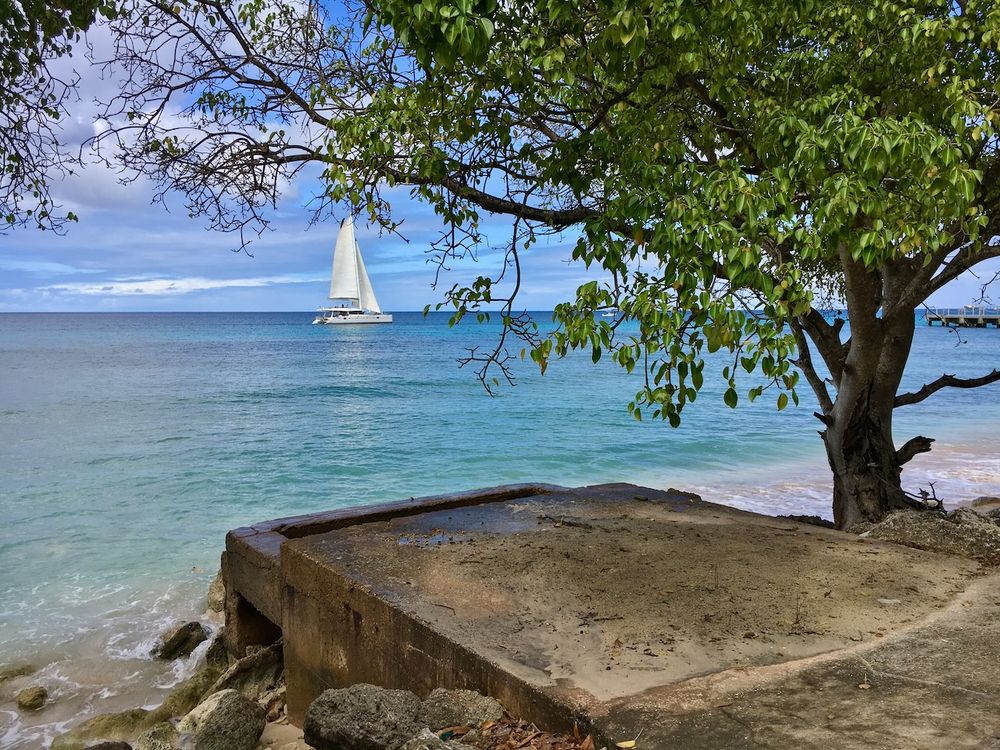 Heywood's beach with old platform & sailboat by Barbados Photographer Logan C Thomas location scouting for catalog