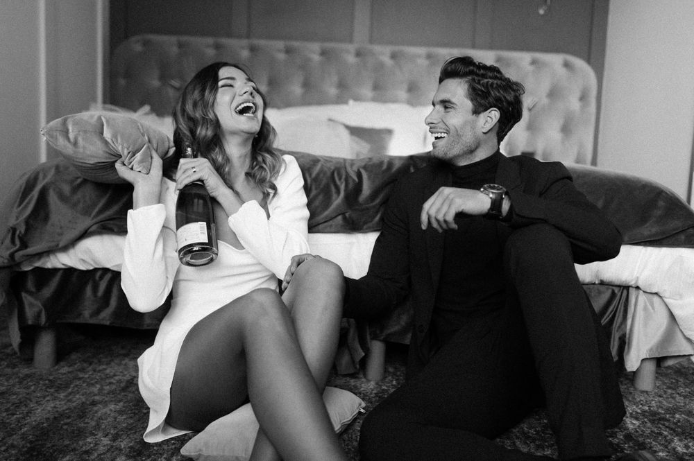 Playful black and white photos of a couple laughing and enjoying each other's company.