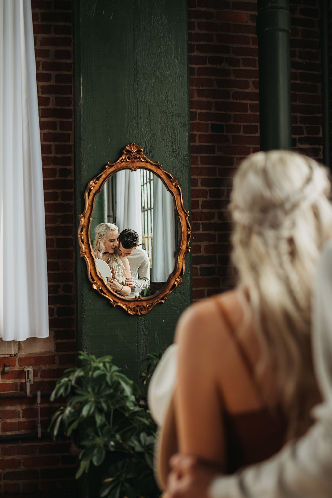 Engaged couple in a mirror in Akron Ohio captured by Jessica Hepp Photography