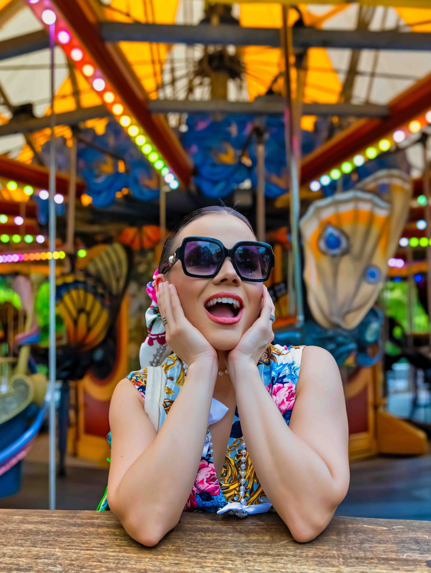 Colorful carnival scene with bright lights and decorative carousel elements.