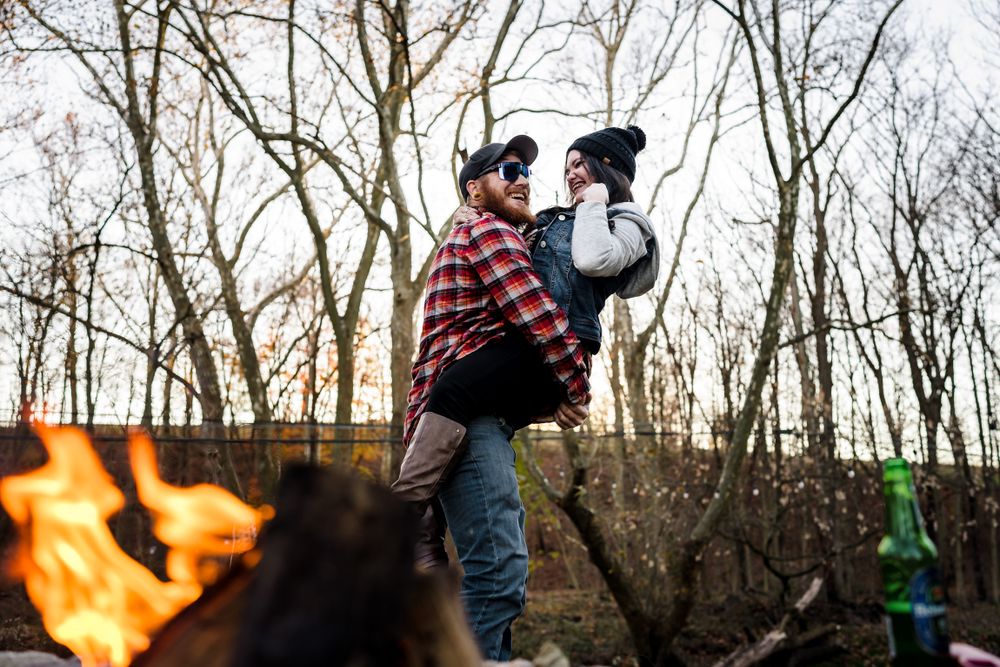 Bare winter trees frame a natural outdoor scene with warm lighting.
