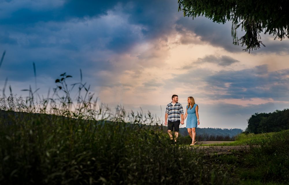 Sunset sky with dramatic clouds over a rural field landscape.