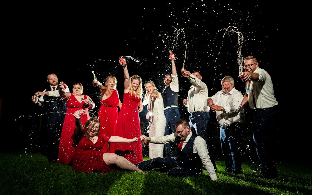 Group celebration scene with sparklers creating festive light trails in the dark.