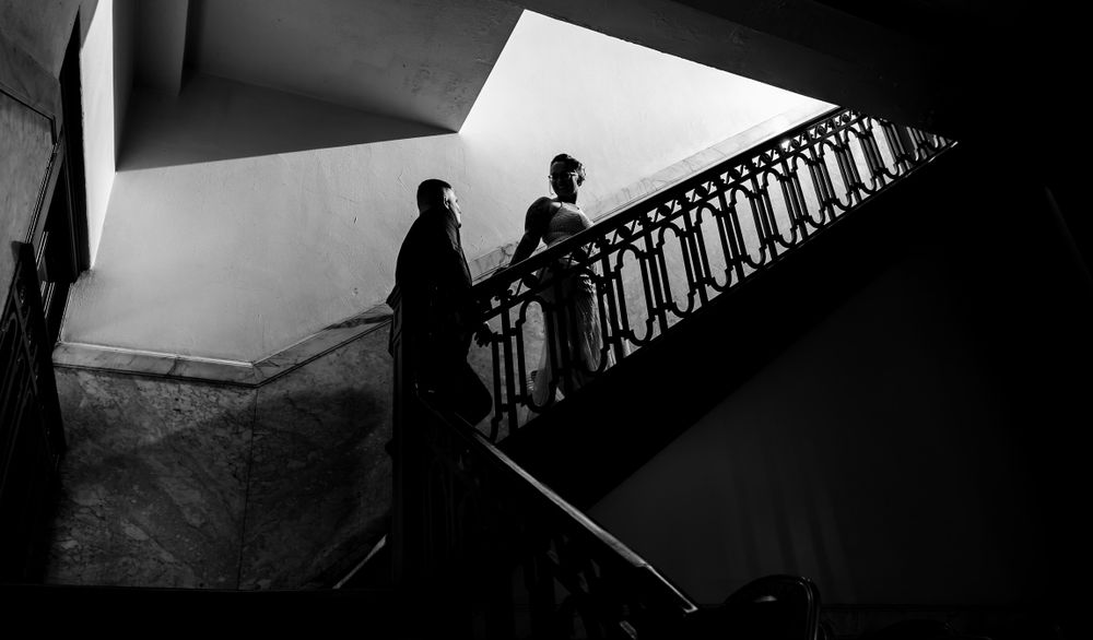 Artistic black and white architectural shot featuring ornate stair railings.