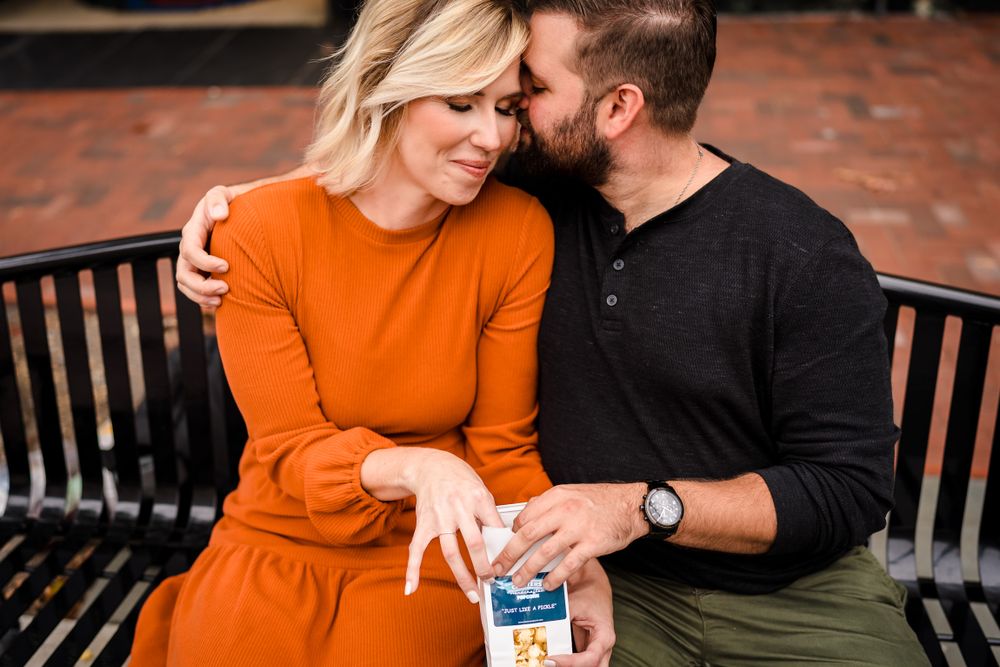 Couple sitting on brick patio with warm orange tones.