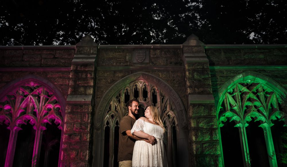 Gothic arches illuminated with dramatic colored lighting create a magical atmosphere.