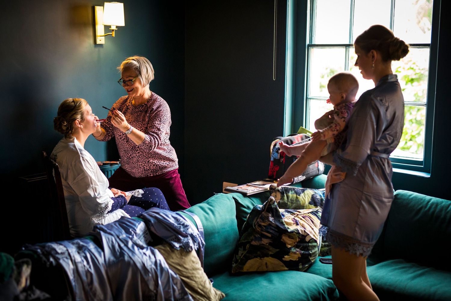 Intimate moments captured in low light during wedding preparations.