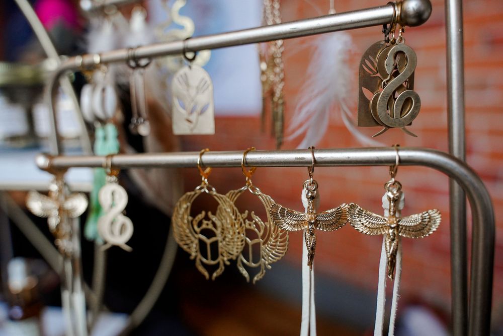 Decorative crosses and religious jewelry displayed on metal hanging racks.