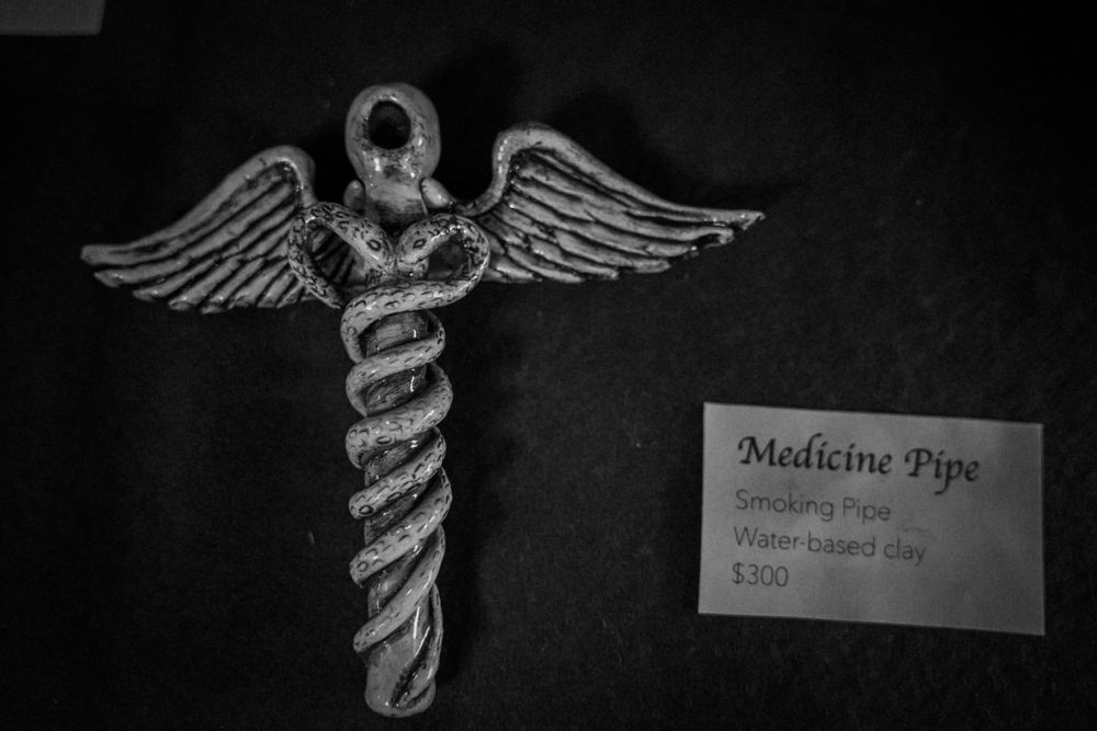 Black and white photograph of a medical caduceus symbol with price tag.