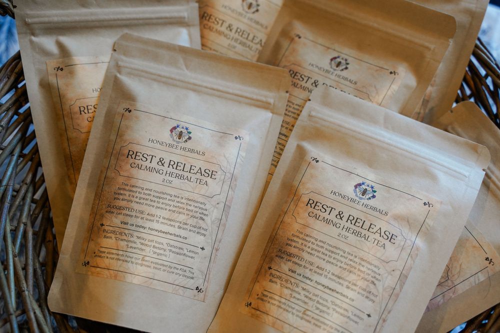 Stack of kraft paper pouches with vintage-style product labels in woven basket.