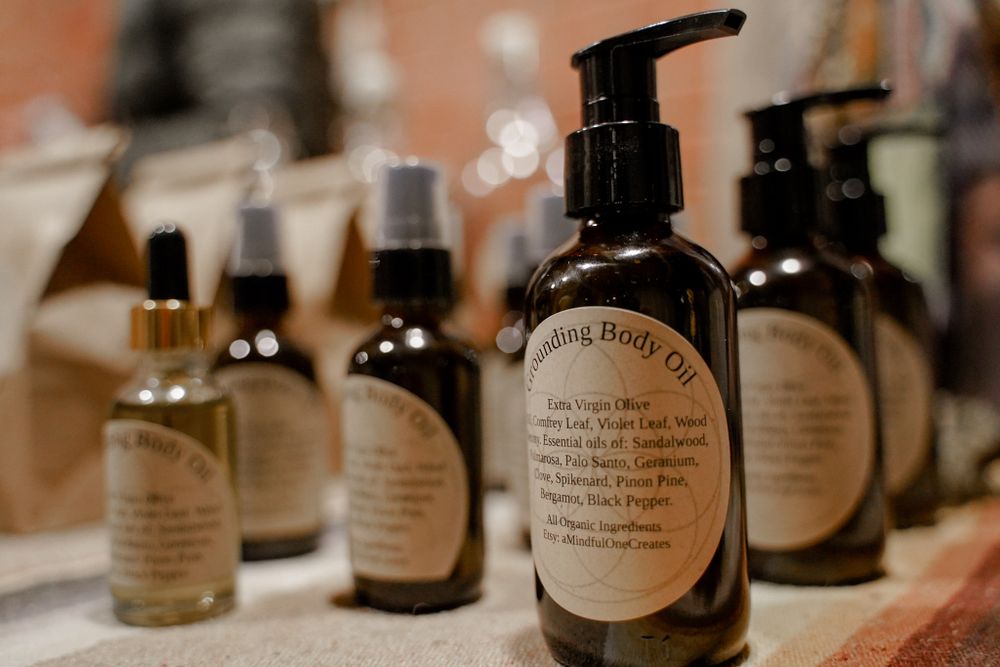 Row of natural beauty product bottles with handwritten labels and pump dispensers.