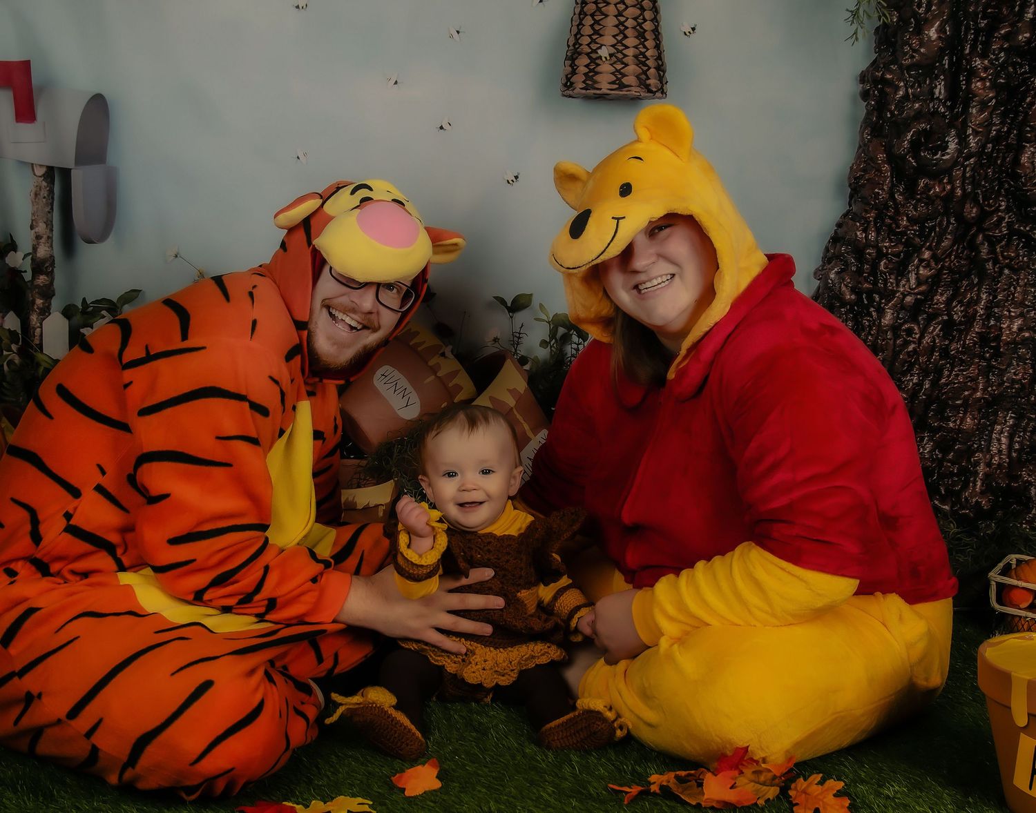 Winnie the Pooh themed costume scene with honey pots and autumn decorations.