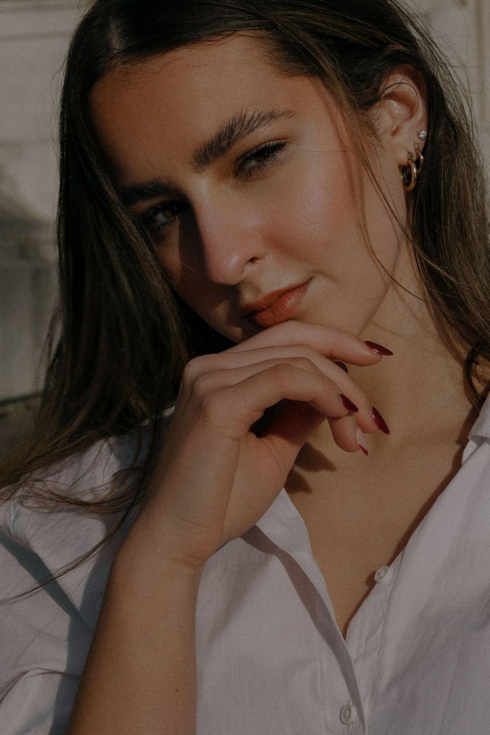 Intimate portrait showing playful expressions while wearing a crisp white shirt.
